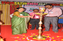 The Chief Guest lighting the lamp during the inauguration